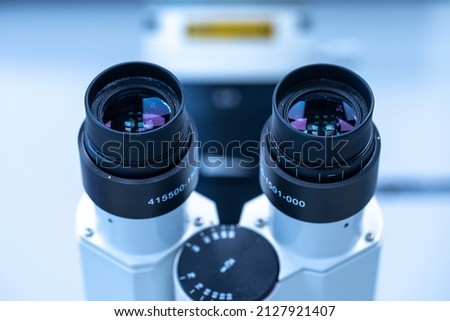 Professional biocular laboratory microscope with stereo eyepiece isolated in lab room. Genuine two piece eyelashes equipment in laboratory Сток-фото © 