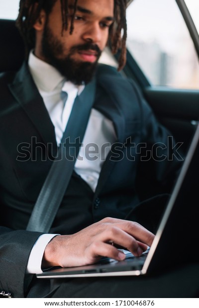 Professional black employee\
using laptop 