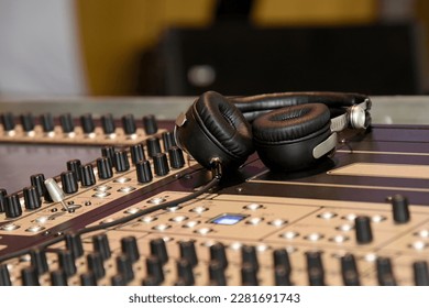 Professional black headphones for DJing on a mixing desk. over-ear headphones - Powered by Shutterstock - Get 15% off with code: PIKWIZARD15