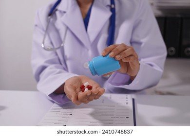 Professional black pharmacist using digital tablet computer Check the list of medicines, medicines, vitamins, health care products. Pharmacist in pharmacy, Asian, African