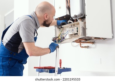 Professional Boiler Service: Qualified Technician Checking A Natural Gas Boiler At Home