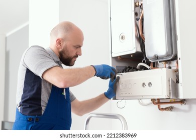 Professional Boiler Service: Qualified Technician Checking A Natural Gas Boiler At Home