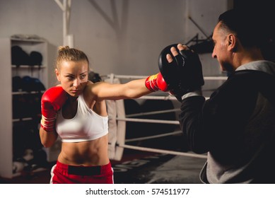 Professional boxer training with a coach - Powered by Shutterstock