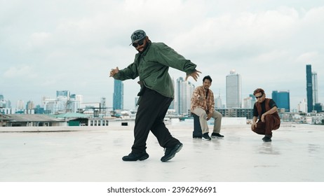 Professional break dance team practice B-boy dance while multicultural friends at rooftop. Young modern dancing group doing hip hop movement. Style,fashion,action. Outdoor sport 2024. Endeavor. - Powered by Shutterstock