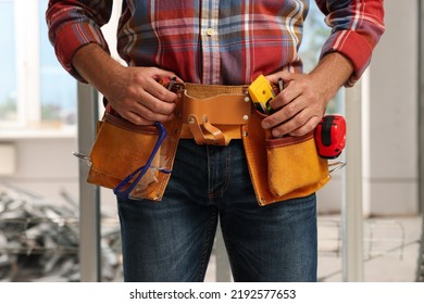 Professional Builder With Tool Belt Indoors, Closeup