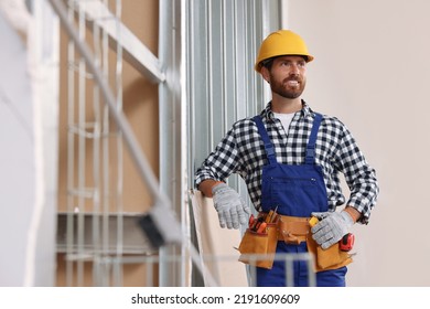 Professional Builder In Uniform With Tool Belt Indoors