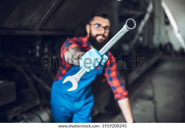 Professional bus mechanic working in vehicle repair
service. 