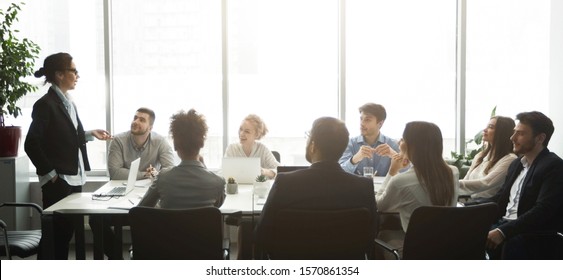 Professional business team having brainstorm meeting in office, side view, panorama