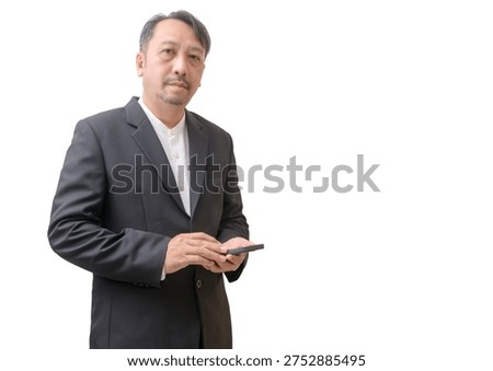 A professional businessman using a smartphone while standing against a clean light background with copy space. The image represents modern business communication, mobile technology, digital connectivity, and professional work in the digital era.