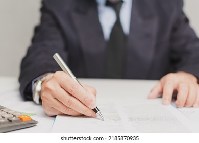 Professional Businessman Wear Suit Hand Holding Pen Writing And Sign Paperwork Or Document Finance At Office, Man Manager Person Handwriting Paper On Clipboard Signature Agreement Approval Business