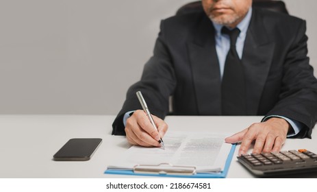 Professional Businessman Wear Suit Hand Holding Pen Writing And Sign Paperwork Or Document Finance At Office, Man Manager Person Handwriting Paper On Clipboard Signature Agreement Approval Business