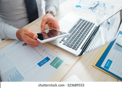 Professional Businessman Working At Desk And Using A Touch Screen Tablet, Technology And Communication Concept