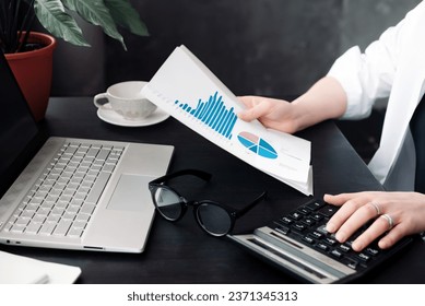 Professional Businesswoman Analyzing Financial Budget and Accounting Data in Office, Calculating Finance Report with Calculator, Strategic Financial Analysis and Budgeting in Action. - Powered by Shutterstock