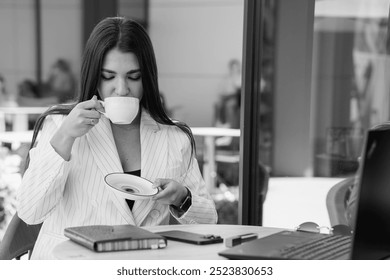 Professional businesswoman enjoying coffee in a modern café setting. - Powered by Shutterstock