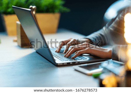 Professional businesswoman sitting at desk and working with her laptop from home