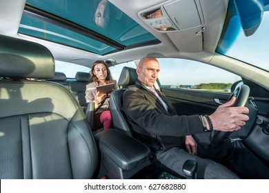 Professional Cab Driver Riding Taxi While Female Passenger Using Digital Tablet