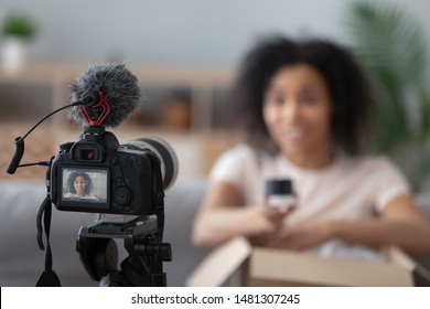 Professional Camera Device Shooting African American Young Woman Blogger Making Unpacking Video At Home, Black Biracial Young Woman Vlogger Influencer Record Content On Cam, Brand Advertising Promo