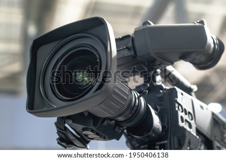 Professional camera. HDTV reportage camcorder, TV equipment service, large zoom lens. Event broadcast technologies, high tech
