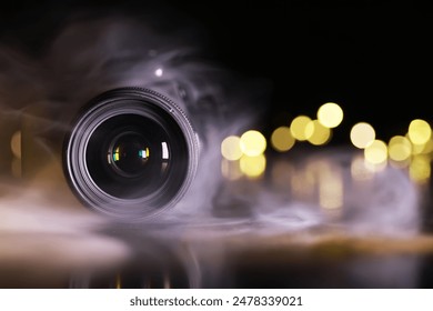 Professional Camera Lens with Dramatic Smoke Effect and Bokeh Lights in Background