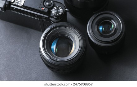 Professional camera with lenses on a black background. Equipment for photographer or videographer