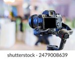 A professional camera on the blurred background of a banquet hall. Professional photo and video shooting.