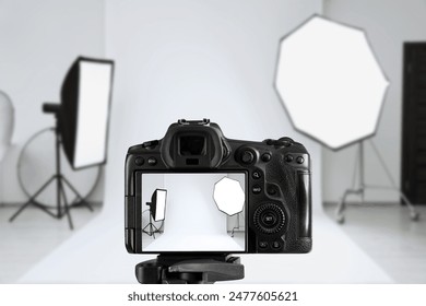 Professional camera on tripod in photo studio - Powered by Shutterstock