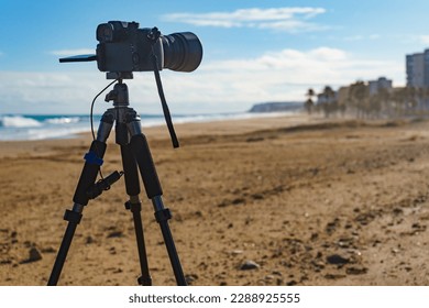 Professional camera on tripod taking picture film video of sea coastal landscape, Spain. - Powered by Shutterstock