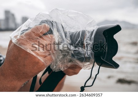 professional camera in a waterproof case that protects against rain and splashes in nature on a rainy day