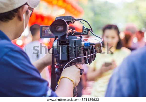  professional cameraman - covering on event with a video\
 
