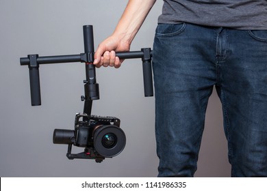 Professional Cameraman Holding Camera Stabilizer Gimbal