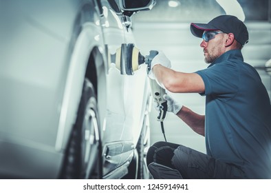 Professional Car Body Waxing By Caucasian Auto Detailing Worker In His 30s. Automotive Theme.