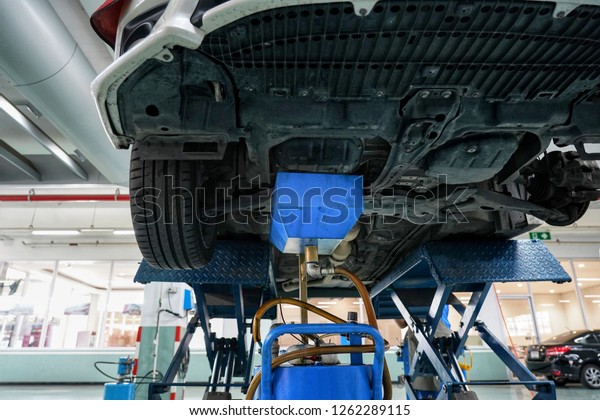 Professional car mechanic changing motor oil in\
automobile engine at maintenance repair service station in a car\
workshop.Automobile metal car engine part details.Engine oil\
change.Car repair.