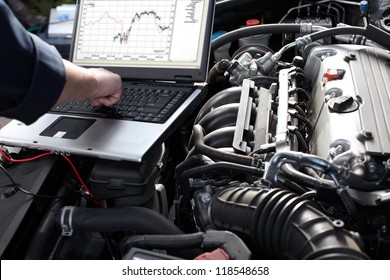 Professional car mechanic working in auto repair service.