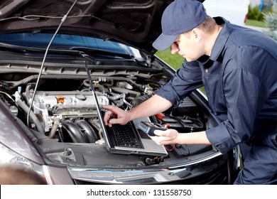 Professional car mechanic working in auto repair service.