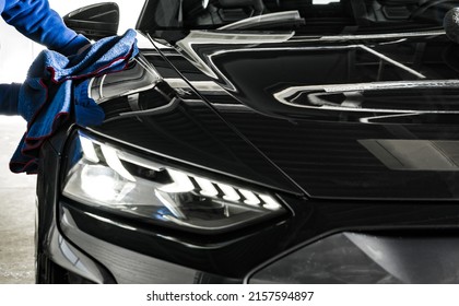 Professional Car Wash and Detailing Worker Cleaning Car Body with a a Soft Cloth. Automotive Industry Theme. - Shutterstock ID 2157594897
