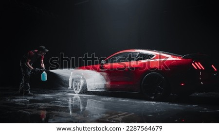 Professional Car Wash Specialist Applying Smart Foam to Prepare a Modern Red Sportscar with Retro Design for Sale at a Dealership Car Center. Commercial Studio Footage for Advertising