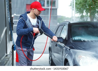 Professional Car Wash Worker Is Washing Client's Car