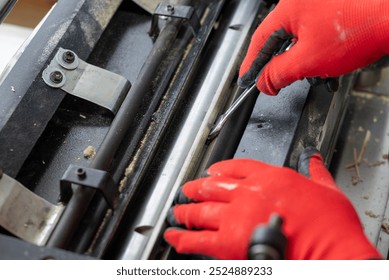 Professional carpenter loosen nut to change knives in his wood sanding cutting machine. Woodworking, maintenance of tools to make high quality wooden furniture - Powered by Shutterstock