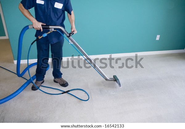 Professional Carpet\
Steam Cleaner Vacuuming a\
Home