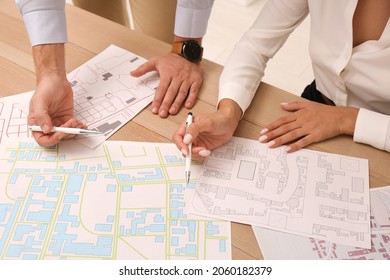 Professional cartographers working with cadastral map at table, closeup - Shutterstock ID 2060182379