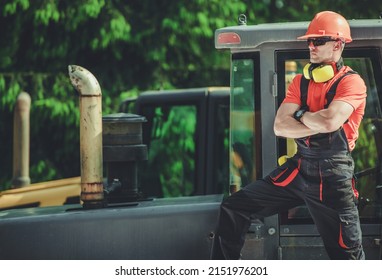 Professional Caucasian Crawler Or Bulldozer Operator In His 30s Staying Next To Heavy Equipment