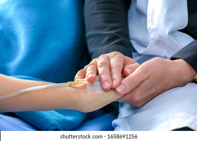 Professional Caucasian Doctor With Stethoscope Holding Suffering Emotional Pain Stressed Patient's Hand To Make Her Feel Comfortable In Hospital. Medical Healthcare.Partnership,trust,medical Concept.