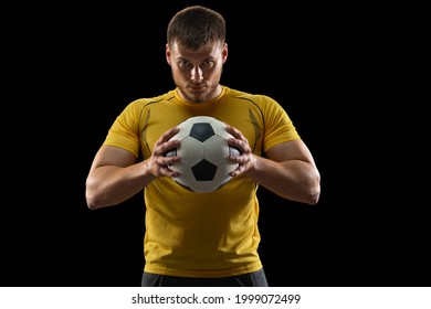Professional caucasian football soccer player standing with ball isolated on black studio background. Concept of sport, movement, energy and dynamic, healthy lifestyle. - Powered by Shutterstock