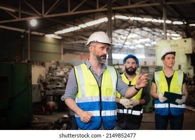 Professional Caucasian manager engineer in safety uniform is training industry factory worker, workshop factory operator, mechanical engineering team production in heavy industrial manufacture factory - Shutterstock ID 2149852477