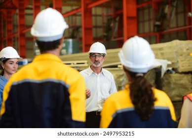 Professional Caucasian manager engineer wearing safety hardhat is training industry worker, workshop factory operator, mechanical engineering team production in heavy industrial manufacture factory. - Powered by Shutterstock