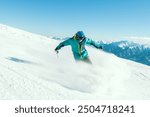 Professional caucasian skier at full speed ski downhill fast motion spray on fresh snow do carving in ski resort while training for competition in ski resort with sunny blue mountains background