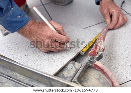 Similar – Image, Stock Photo The worker cuts the parquet on a circular saw