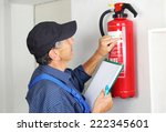 A Professional checking aFire extinguisher