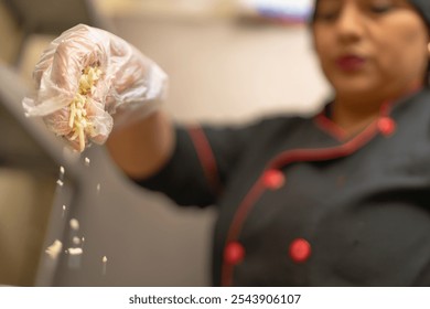 Professional chef adding finishing touches to a pizza by sprinkling grated cheese in a commercial kitchen - Powered by Shutterstock