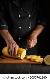 Professional Chef Cuts Ripe Yellow Marrow With A Knife. Fried Zucchini Is Great Diet For Breakfast Or Lunch. Work Environment On The Kitchen Table Of Restaurant